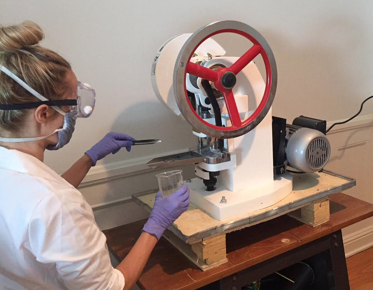 Picture showing a woman working with a machine