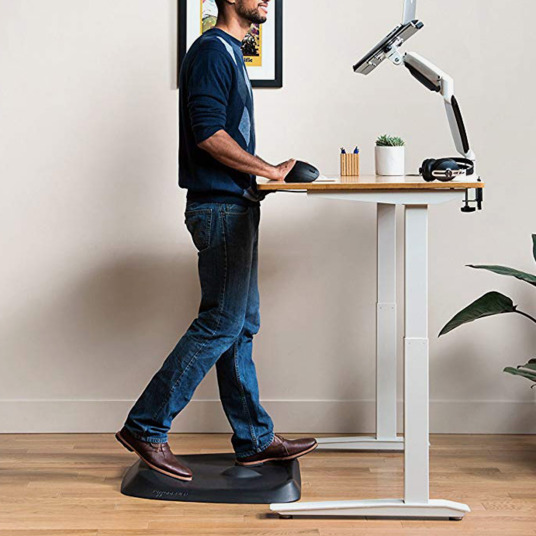 Picture showing a man using a standing desk