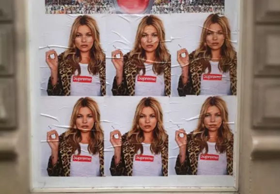 Photo of a street ad showing a woman wearing Supreme branded clothing