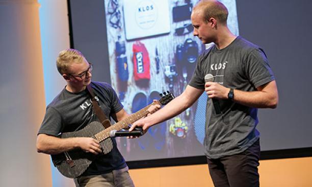 Picture showing Adam demonstrating KLOS guitars